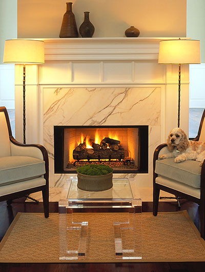 Formal living room detail of marble fireplace surround with painted custom wood mantel.